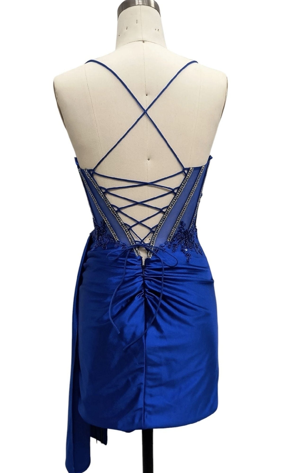 Back view of the Lace-Up Short Hoco Dress: 12659 in royal blue satin, featuring crisscross lace-up straps and ruched back detailing—an ideal short corset party or homecoming dress.